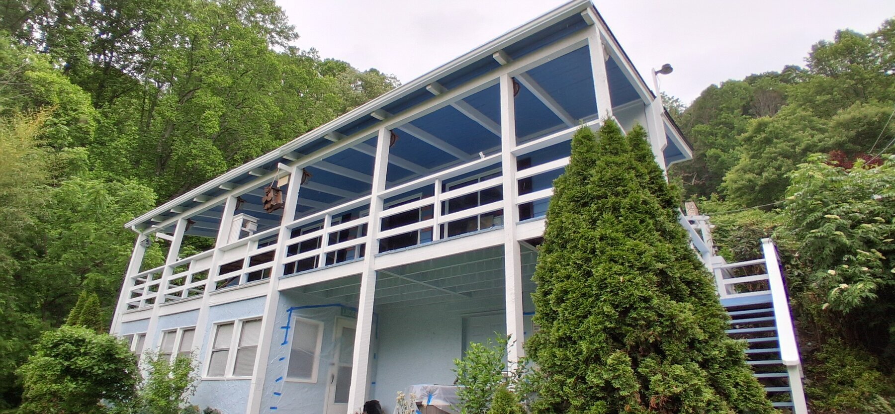 A two-story blue mountain home painted by Flying Colors Painting in Sylva, NC