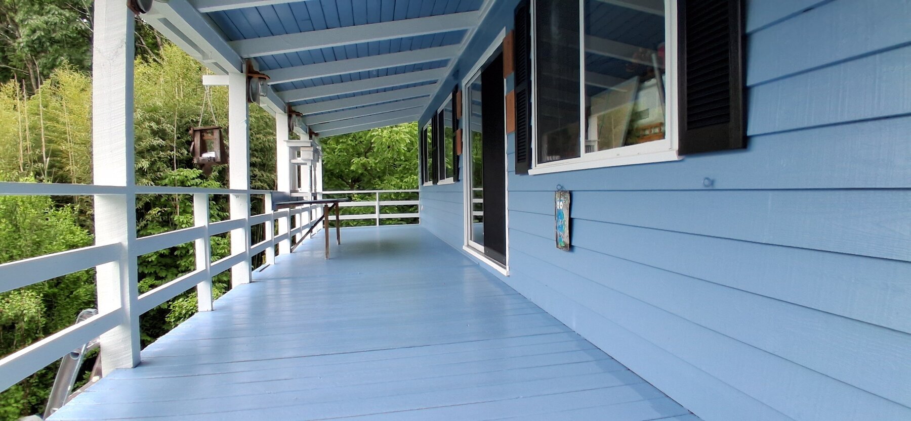 Blue painted deck after pressure washing