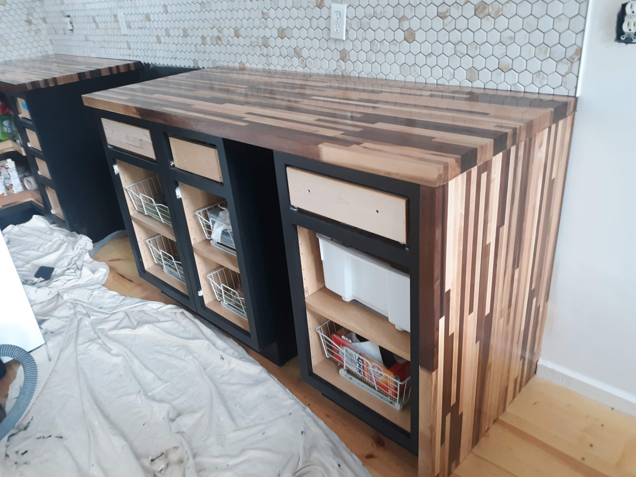 Butcher block countertop detail with mosaic hex tile backsplash